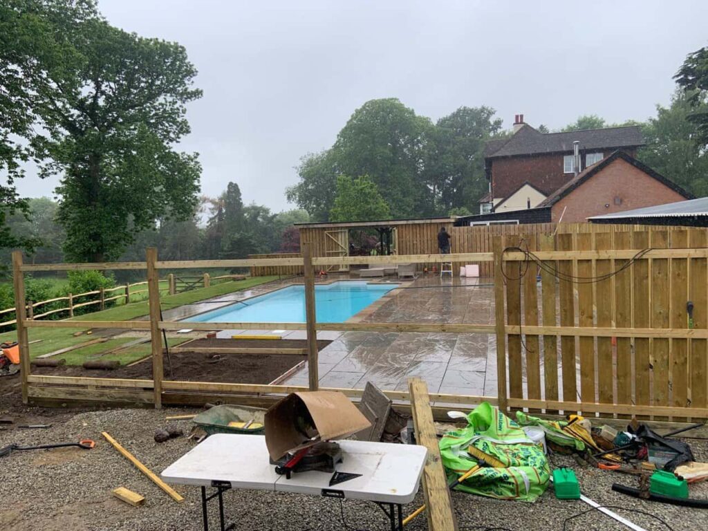 This is a photo of Bespoke custom fencing installed around a swimming pool by Fast Fix Fencing Bury St Edmunds