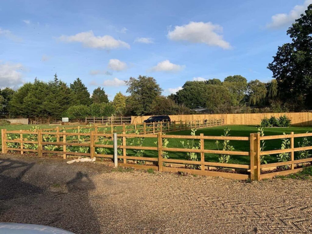 This is a photo of post and rail fencing with a gravel board installed at the base to create a flower bed, and at the rear is feather edge fencing along the edge of the garden. All works carried out by Fast Fix Fencing Bury St Edmunds